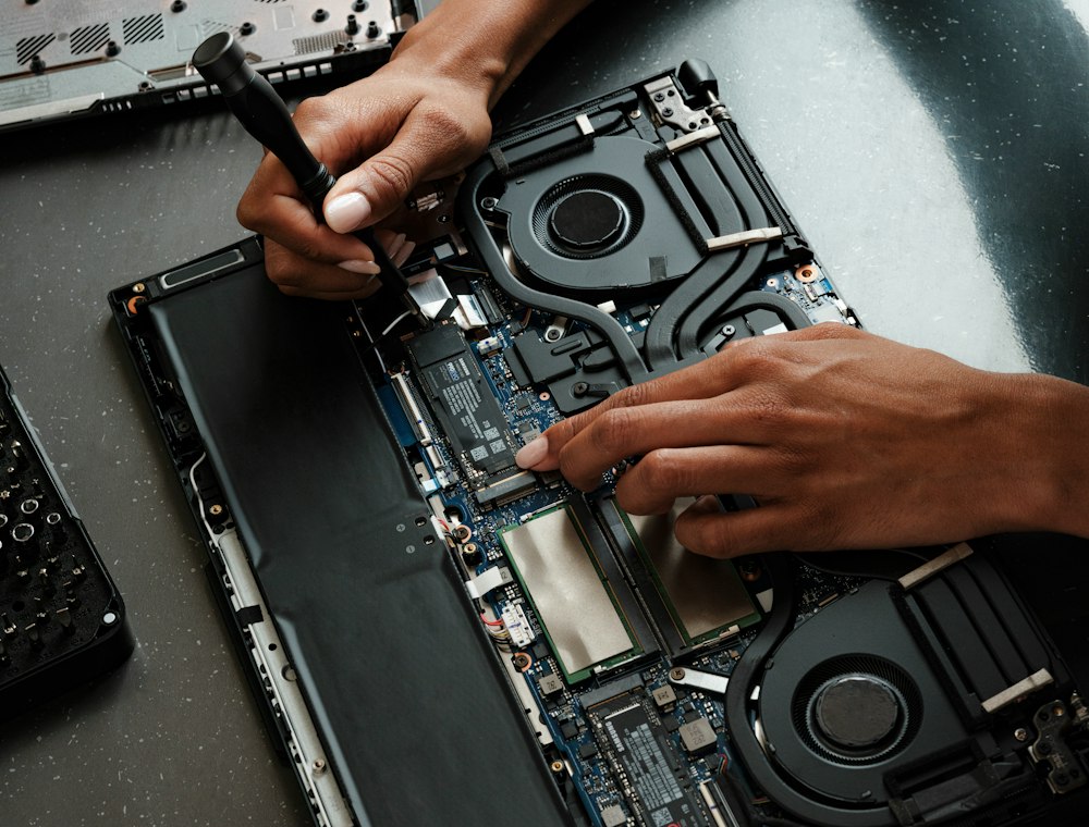 Technician repairing a laptop